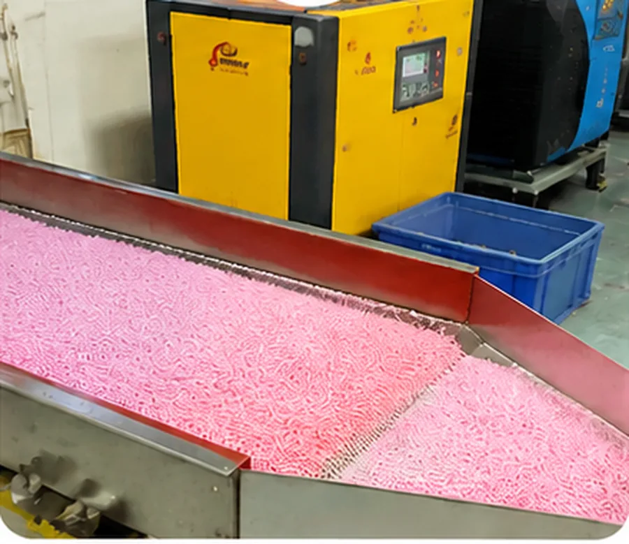 Vibration screening machine removing burrs from freshly molded pink fuse beads